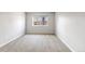 Bright bedroom with neutral carpet, white walls, and natural light from a large window at 6960 S Knolls Way, Centennial, CO 80122