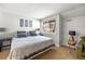 Bedroom featuring a comfortable bed, modern decor, and a window providing natural light at 6960 S Knolls Way, Centennial, CO 80122