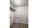 Compact walk-in closet with neutral carpet and built-in shelving for organization at 6960 S Knolls Way, Centennial, CO 80122