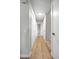 Hallway with wood-look flooring, linen closet, and neutral paint color at 6960 S Knolls Way, Centennial, CO 80122