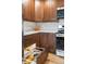 Kitchen features custom cabinets with pull out shelves, modern appliances, and sleek white countertops at 6960 S Knolls Way, Centennial, CO 80122