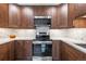 Well-equipped kitchen featuring stainless steel appliances, modern backsplash, and dark wood cabinets at 6960 S Knolls Way, Centennial, CO 80122