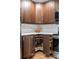Kitchen features corner storage and custom cabinets with modern appliances and sleek white countertops at 6960 S Knolls Way, Centennial, CO 80122