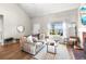 Comfortable living room featuring neutral paint, hardwood floors, modern decor, and a cozy seating area at 6960 S Knolls Way, Centennial, CO 80122