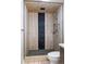 This tiled shower has black pebble flooring, vertical black tile, a modern shower head, and sleek fixtures at 6960 S Knolls Way, Centennial, CO 80122