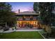 Rear view of a brick home with a large backyard and outdoor seating area at 1040 N Humboldt St, Denver, CO 80218