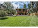 Expansive backyard with lush lawn, inviting patio, and classic brick home showcasing outdoor living at 1040 N Humboldt St, Denver, CO 80218