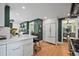 Spacious kitchen with white cabinetry and bar seating open to adjacent rooms at 1040 N Humboldt St, Denver, CO 80218