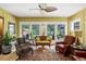 Inviting living room featuring a ceiling fan and backyard access through bright glass doors at 1040 N Humboldt St, Denver, CO 80218