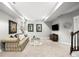 Finished basement area with a comfortable seating area, television, and stairway access at 5450 Uinta St, Denver, CO 80238