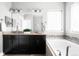 Bright bathroom featuring double vanity with dark cabinets, granite counters, tub and decorative tile detail at 5450 Uinta St, Denver, CO 80238