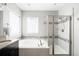 Bathroom with a soaking tub, glass enclosed shower, granite countertops and bright, natural light at 5450 Uinta St, Denver, CO 80238