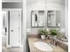 Bathroom sink featuring granite countertop, brushed nickel faucet, with a large framed mirror at 5450 Uinta St, Denver, CO 80238