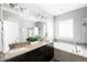 Bright bathroom features a double vanity with granite countertops, soaking tub, and walk-in shower at 5450 Uinta St, Denver, CO 80238