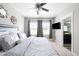 Serene bedroom boasts a comfortable bed, ceiling fan, and access to ensuite bathroom at 5450 Uinta St, Denver, CO 80238