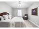 Cozy bedroom with white bedding, neutral walls, and an inviting reading nook at 5450 Uinta St, Denver, CO 80238