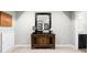 Elegant entryway features a carved wood console table with decorative mirror and white wainscoting at 5450 Uinta St, Denver, CO 80238