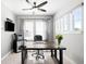 Home office with ceiling fan, modern desk, and large windows for plenty of natural light at 5450 Uinta St, Denver, CO 80238