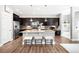 Modern kitchen with dark cabinets, stainless steel appliances, and a spacious center island at 5450 Uinta St, Denver, CO 80238