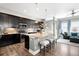 Spacious kitchen with dark cabinets, granite countertops, and a center island with seating at 5450 Uinta St, Denver, CO 80238