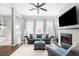 Comfortable living room features a fireplace, ceiling fan, and ample natural light at 5450 Uinta St, Denver, CO 80238