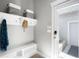 Functional mudroom features built-in bench, shelving, and convenient access to the outside at 5450 Uinta St, Denver, CO 80238