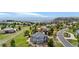 Aerial view showcases a home's location with sprawling neighborhood, green landscape and mountain backdrop at 6635 Tremolite Dr, Castle Rock, CO 80108