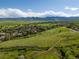 Stunning aerial view of a green neighborhood with mountain views under a sunny blue sky at 12420 W Atlantic Ave, Lakewood, CO 80228