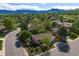 Stunning aerial view of a charming home nestled in a lush, green neighborhood with mountain views at 12420 W Atlantic Ave, Lakewood, CO 80228