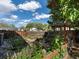 The backyard has vegetable gardens, a potting area, and mature landscaping at 12420 W Atlantic Ave, Lakewood, CO 80228