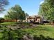 Expansive backyard features a deck, pergola, mature landscaping, and healthy green grass at 12420 W Atlantic Ave, Lakewood, CO 80228