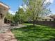 Manicured backyard features an outdoor dining area and healthy green grass at 12420 W Atlantic Ave, Lakewood, CO 80228