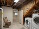 Basement laundry area shows washer/dryer and rocking chair at 12420 W Atlantic Ave, Lakewood, CO 80228