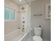 Bright bathroom with white tile and a bathtub with shower at 12420 W Atlantic Ave, Lakewood, CO 80228