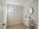 Modern bathroom features a white vanity, oval mirror, light wood floors and neutral walls at 12420 W Atlantic Ave, Lakewood, CO 80228