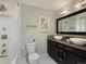 Bathroom featuring vessel sinks, a tile shower, and dark cabinets at 12420 W Atlantic Ave, Lakewood, CO 80228