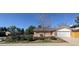 Charming brick home with a well-manicured front yard and attached two car garage at 12420 W Atlantic Ave, Lakewood, CO 80228