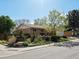Well-maintained home featuring a manicured lawn and mature trees in a serene neighborhood at 12420 W Atlantic Ave, Lakewood, CO 80228