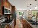 Modern kitchen with stainless steel appliances, granite counters, and hardwood floors at 12420 W Atlantic Ave, Lakewood, CO 80228