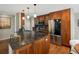 Open kitchen with granite countertops, stainless steel appliances, and wood cabinetry at 12420 W Atlantic Ave, Lakewood, CO 80228