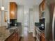 Well-lit kitchen with dark backsplash, stainless steel appliances, and wood cabinets at 12420 W Atlantic Ave, Lakewood, CO 80228