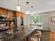 Kitchen featuring granite countertops, stainless steel appliances, wood cabinets, and a breakfast bar at 12420 W Atlantic Ave, Lakewood, CO 80228