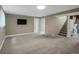 Spacious living room features carpet, large window, and access to stairs and laundry at 12420 W Atlantic Ave, Lakewood, CO 80228