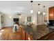 Bright living room featuring hardwood floors, a ceiling fan, and a modern open floorplan to kitchen at 12420 W Atlantic Ave, Lakewood, CO 80228