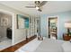 Bright main bedroom with a ceiling fan and a view to the ensuite bath and walk-in closet at 12420 W Atlantic Ave, Lakewood, CO 80228