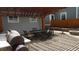 Inviting outdoor patio area with a built-in grill, dining table, and cozy fire pit at 4353 Wolff St, Denver, CO 80212