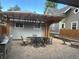 Backyard patio area with outdoor seating and dining set, featuring a pergola, built in grill and fire pit at 4353 Wolff St, Denver, CO 80212