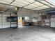 Inside of garage with workbench, shelving, and large television at 4353 Wolff St, Denver, CO 80212