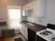 Cozy kitchen with white cabinets, updated appliances, and natural light at 4353 Wolff St, Denver, CO 80212