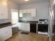 Functional kitchen featuring white cabinetry, stainless steel appliances, and tile flooring at 4353 Wolff St, Denver, CO 80212